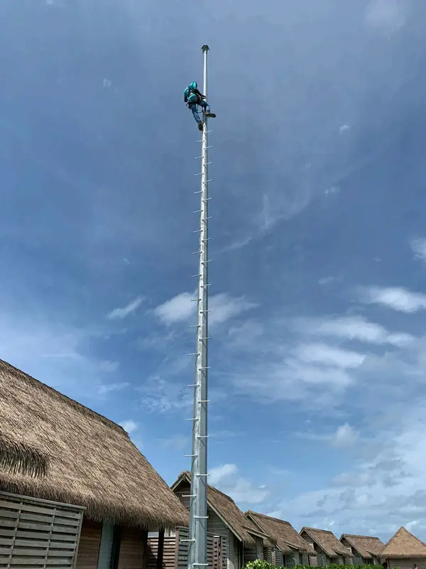 Tall mast against a blue sky